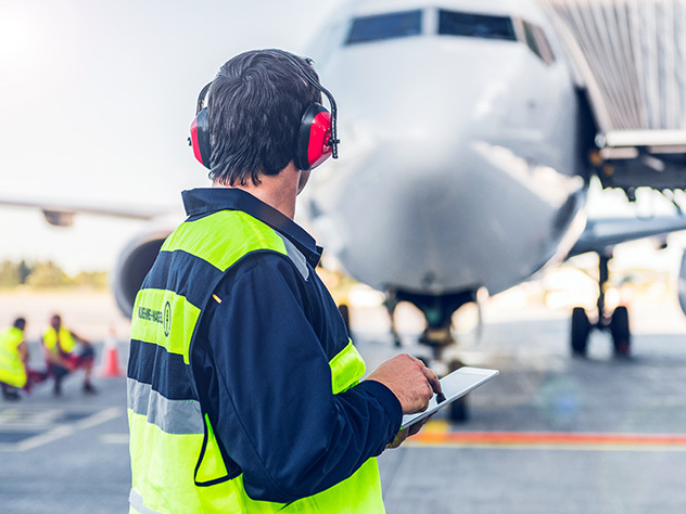 men operating an airplane on the grown